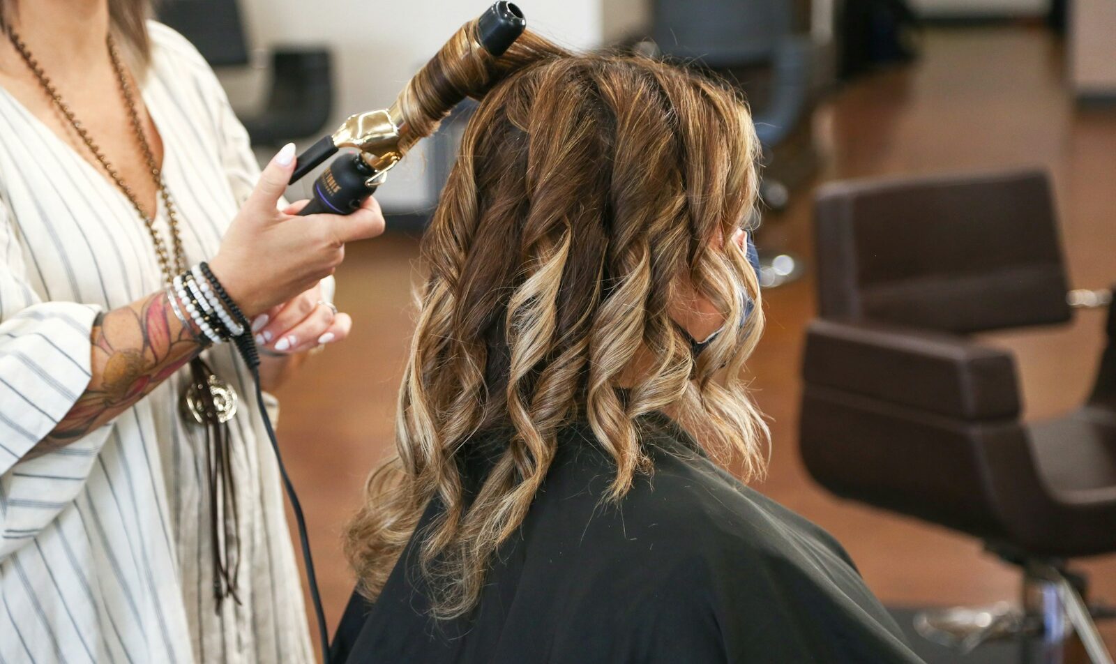 woman in black long sleeve shirt holding black smartphone