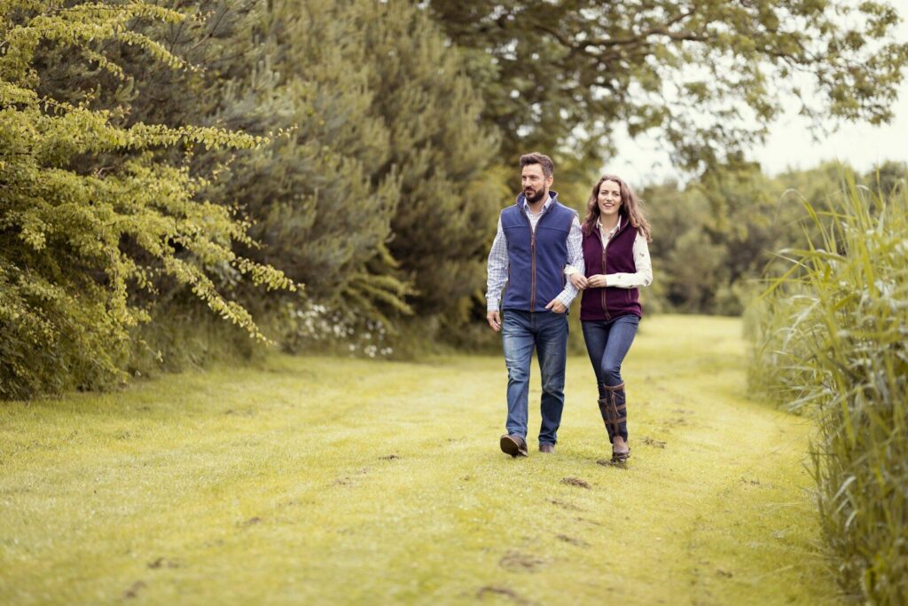 a man and a woman walking down a path